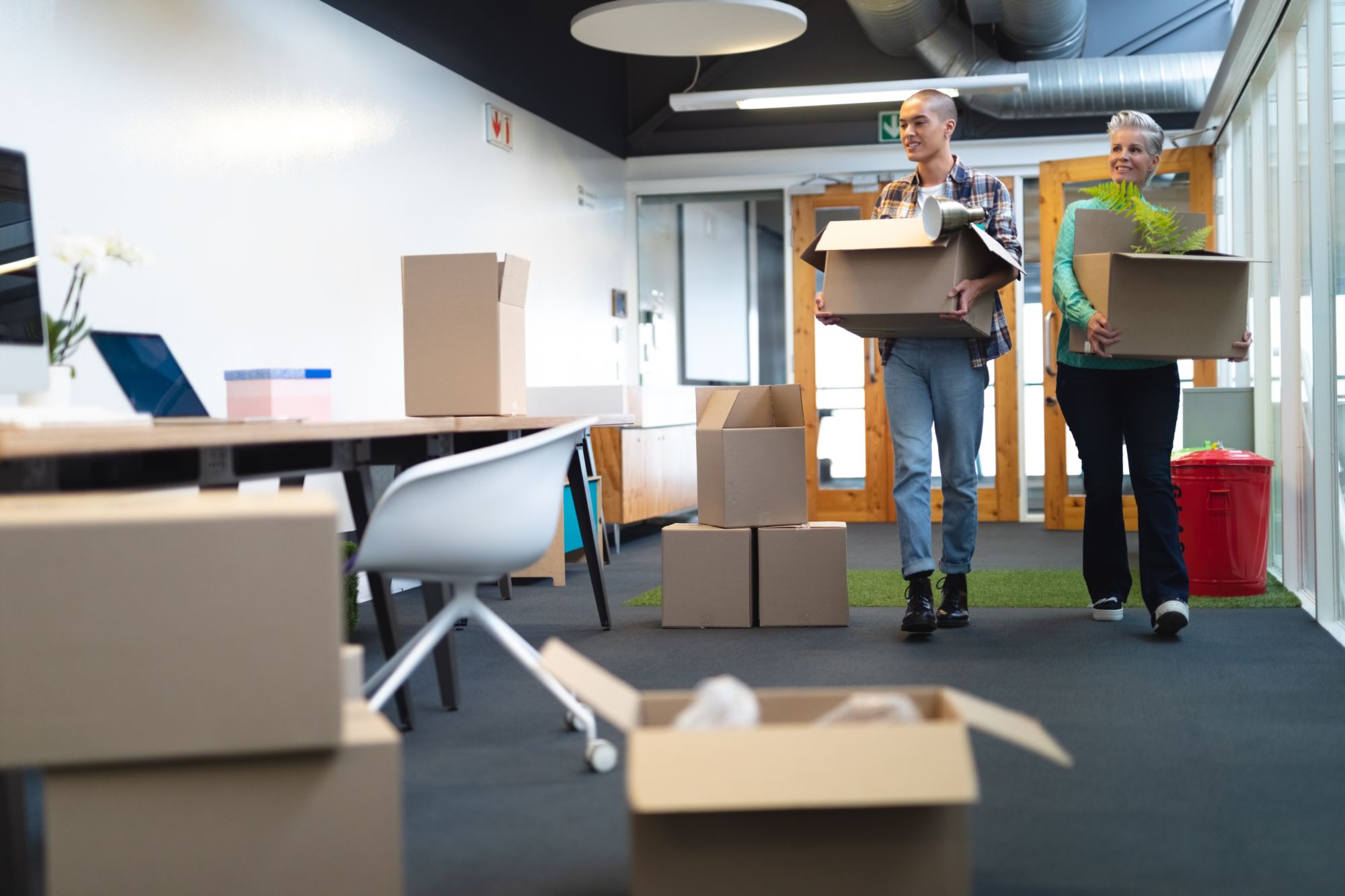 Business executives carrying cardboard boxes